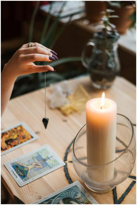 A serene tarot reading setup with a pendulum and g