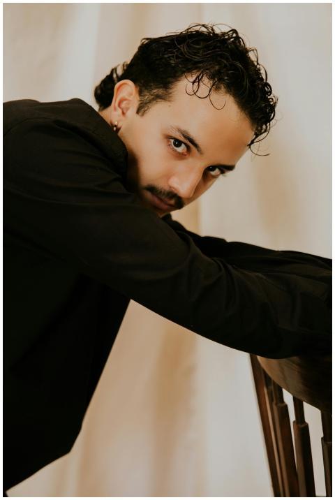 Close-up portrait of a man in a black jacket leani