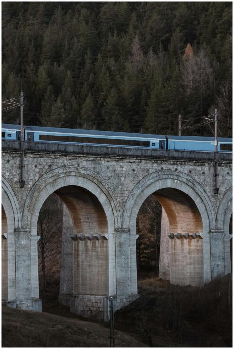 A blue train travels over the historic Semmering R