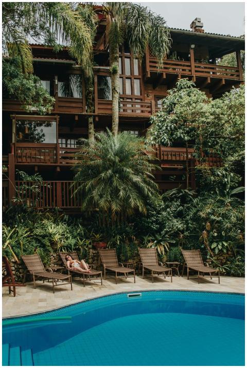 Relaxing poolside at a luxury resort with lush tro