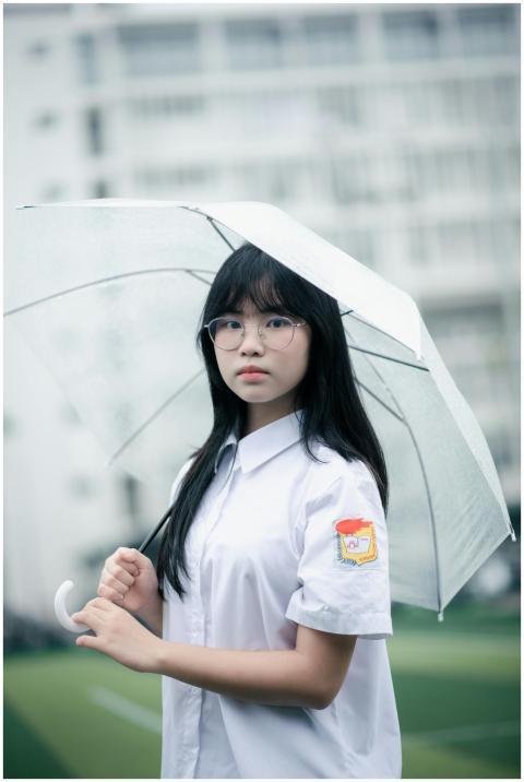 Portrait of a young woman holding an umbrella on a