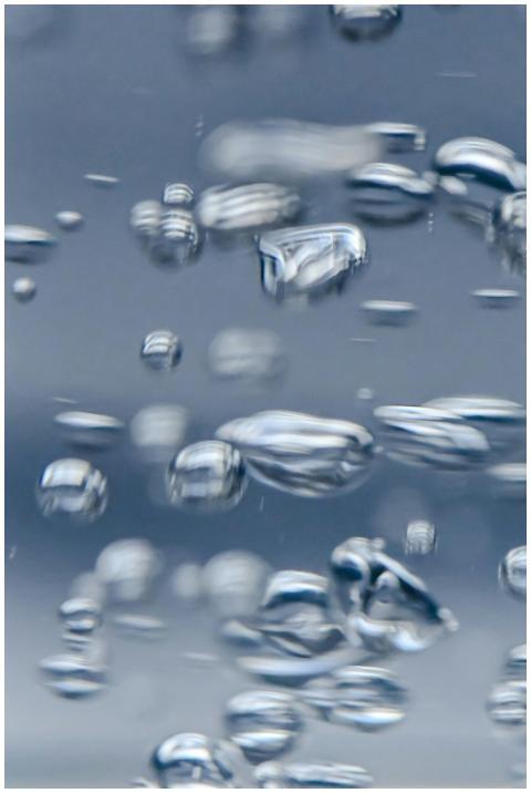 Detailed close-up of water bubbles moving in a cle