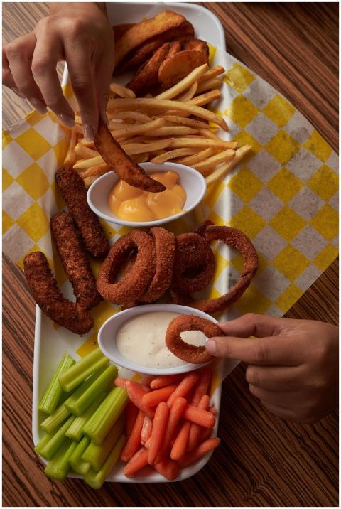 Flat lay of assorted fried snacks with dipping sau