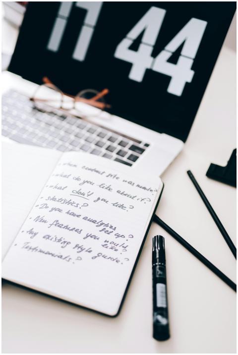 A black and white workspace setup featuring a lapt