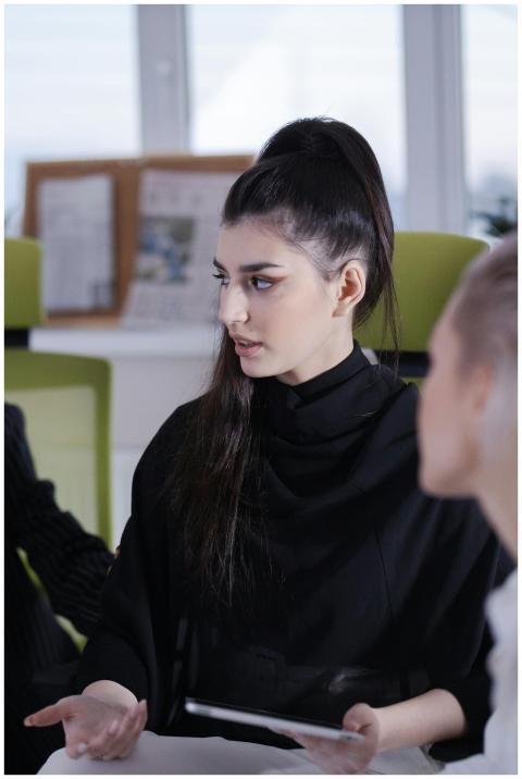 Young woman in office attire actively participatin