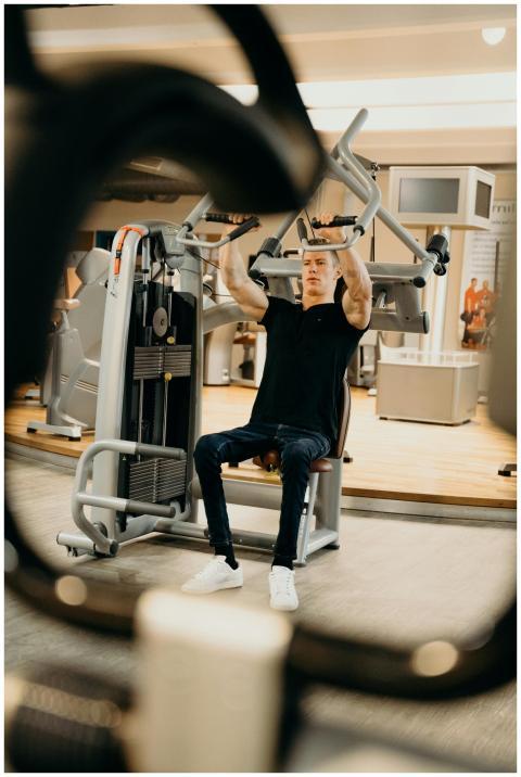 An adult man performing a workout on a fitness mac
