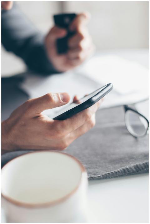 Hands holding a smartphone and credit card for onl