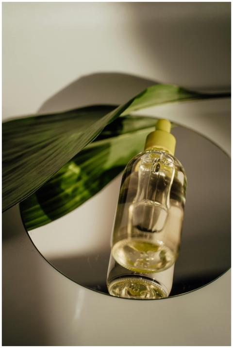 A stylish vertical shot of a cosmetic serum bottle