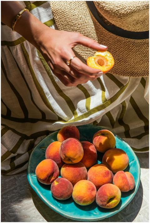 A vibrant display of fresh peaches in a bowl with
