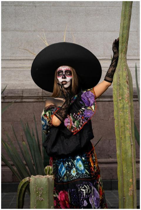 Colorful Dia de los Muertos portrait featuring a w