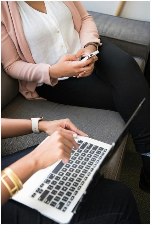 Two professional women collaborating indoors using