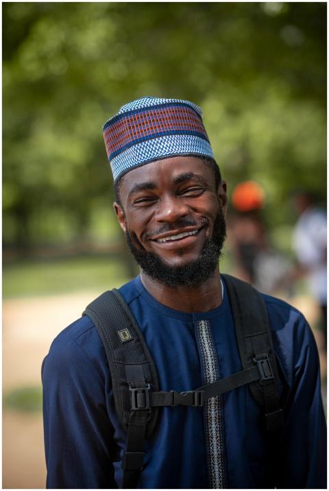 A cheerful Nigerian man wearing traditional attire