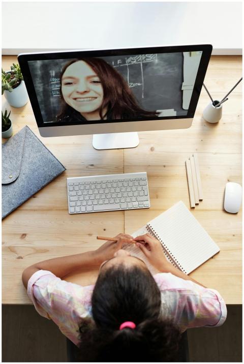 Teen girl participates in online class from home,