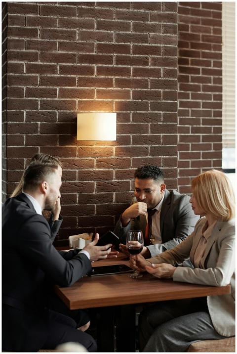 Business professionals discuss strategies over cof