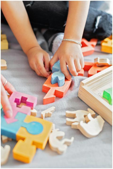 Close-up of children's hands assembling colorful w