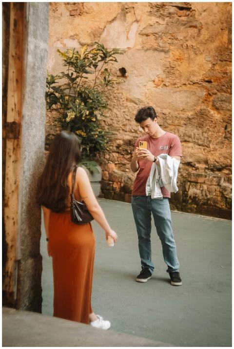A young couple photographing each other against a