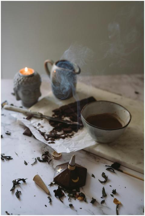 Cozy setting with a steaming bowl of cocoa and a c