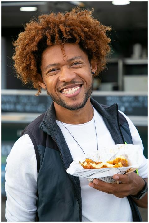 Cheerful young African American male with curly ha