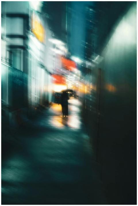 Blurry urban street scene with a solitary figure h