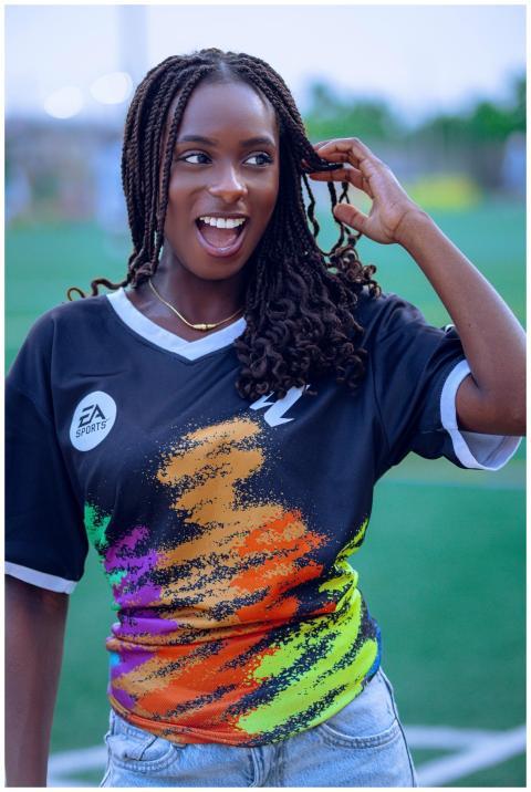Joyful woman with braids wearing a vibrant sports