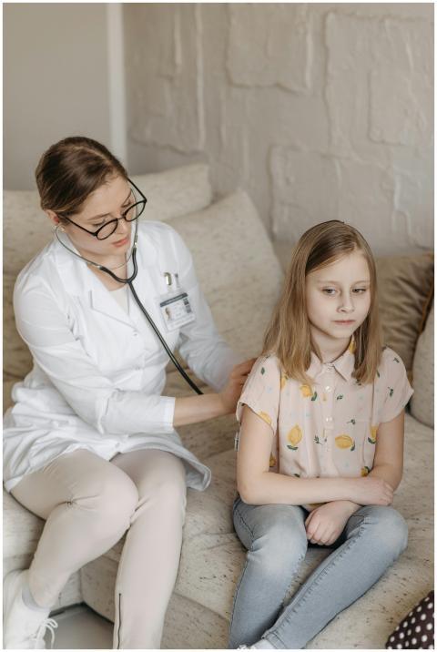 A doctor conducts a health checkup for a young gir