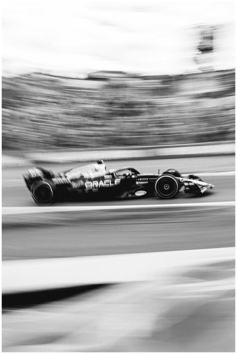 Black and white photo of a Formula 1 car racing in