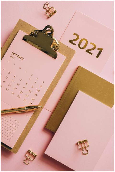 Flat lay of a 2021 calendar and office stationery