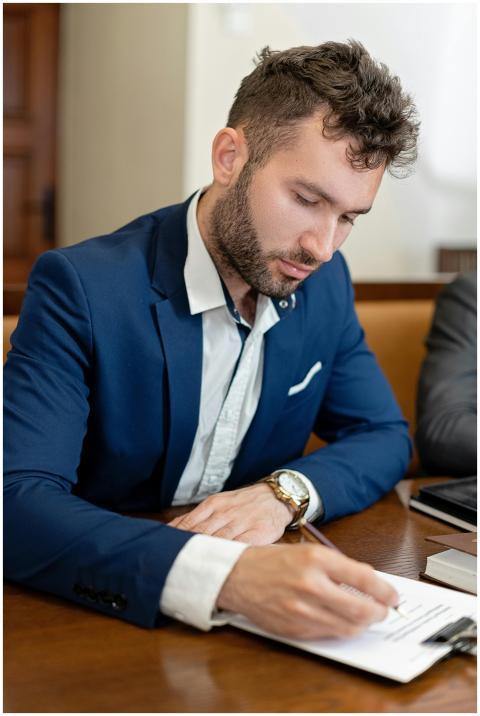 Business professional in suit signs important docu