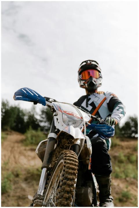 Dirt bike rider wearing protective gear, showcasin