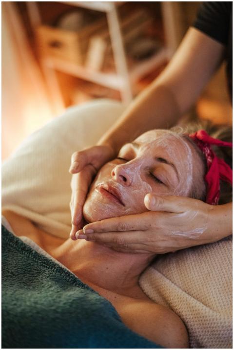 A woman enjoys a calming facial treatment, highlig