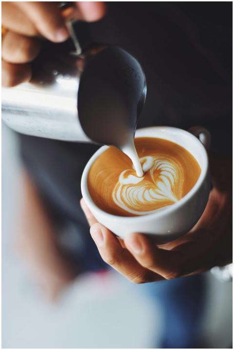 Close-up of barista pouring milk to create stunnin