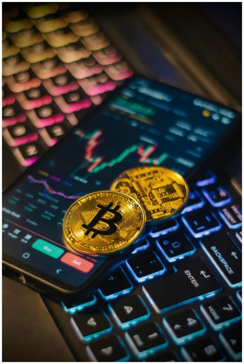 Colorful keyboard with Bitcoin coins and trading s