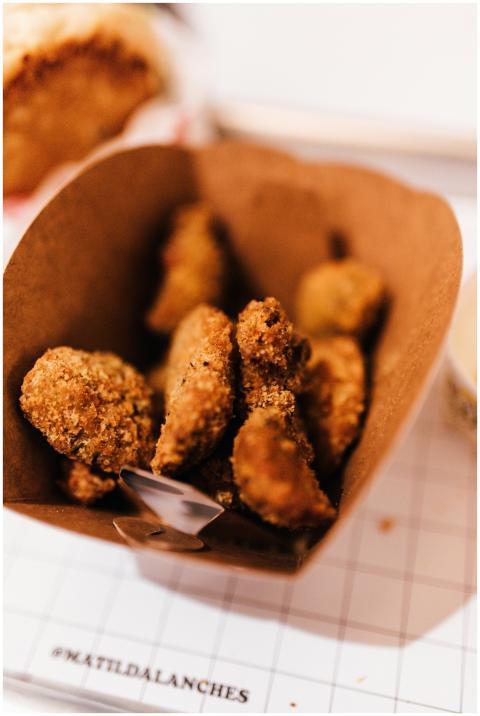 Closeup of crispy fried chicken pieces in a paper