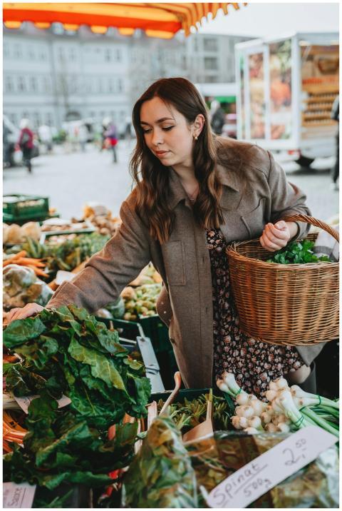Caucasian woman shopping for fresh vegetables at a