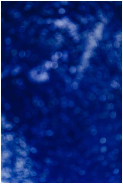 Abstract blue bokeh background with a blurry glitt