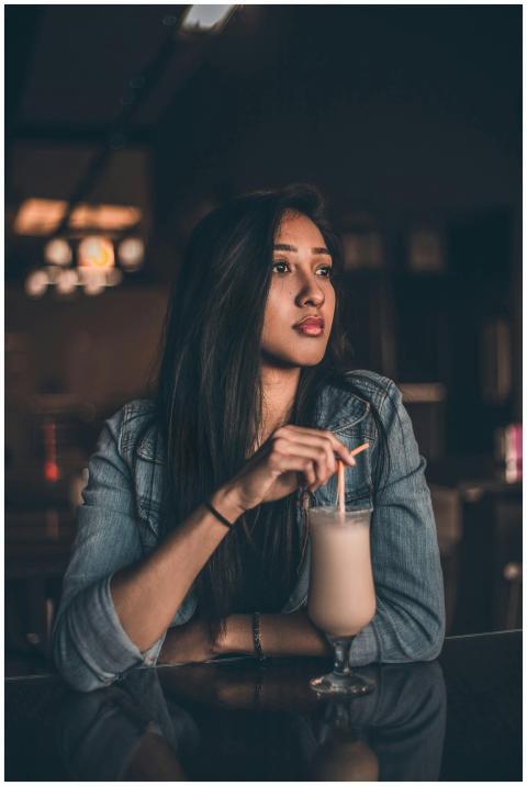 Portrait of a woman enjoying a cocktail at a chic