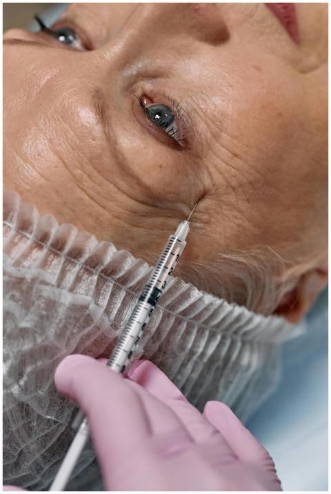 Close-up view of a senior woman receiving an anti-
