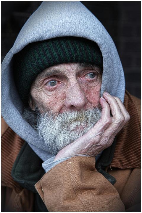 Portrait of an elderly man in a hoodie, capturing