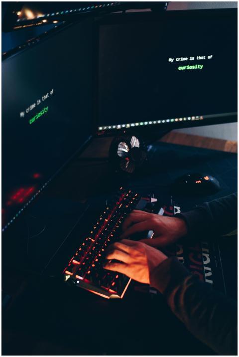 High angle of crop anonymous hacker stealing infor