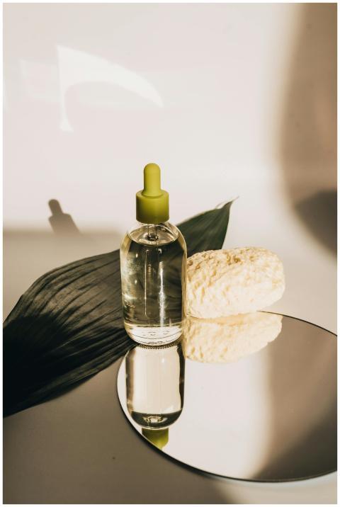 Aesthetic arrangement of serum bottle with leaf, s
