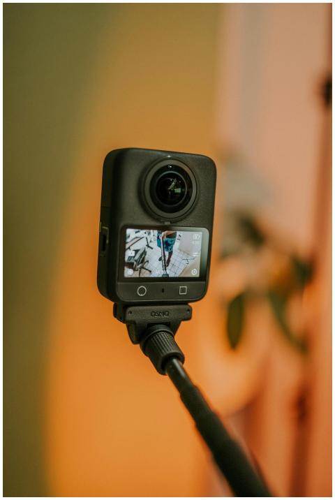 Close-up of a camera on a tripod capturing a scene