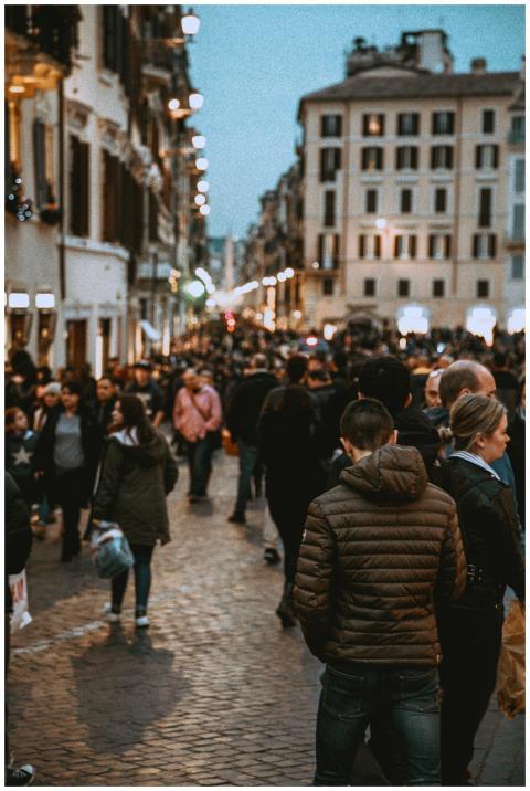 A vibrant street filled with people in the evening
