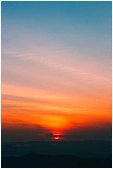 Dramatic sunrise with vibrant orange and blue hues
