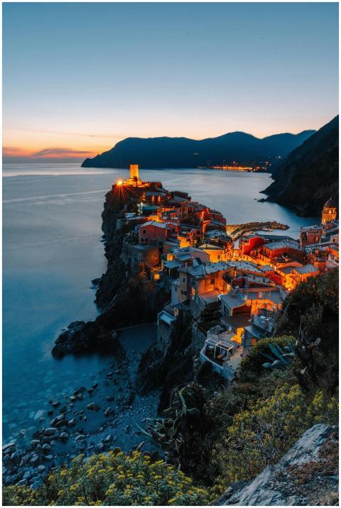 Stunning sunset view of Vernazza village illuminat