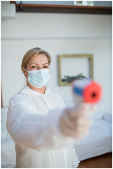 A healthcare professional in protective gear using