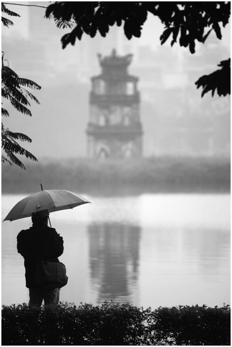 A contemplative silhouette with umbrella at Hoan K