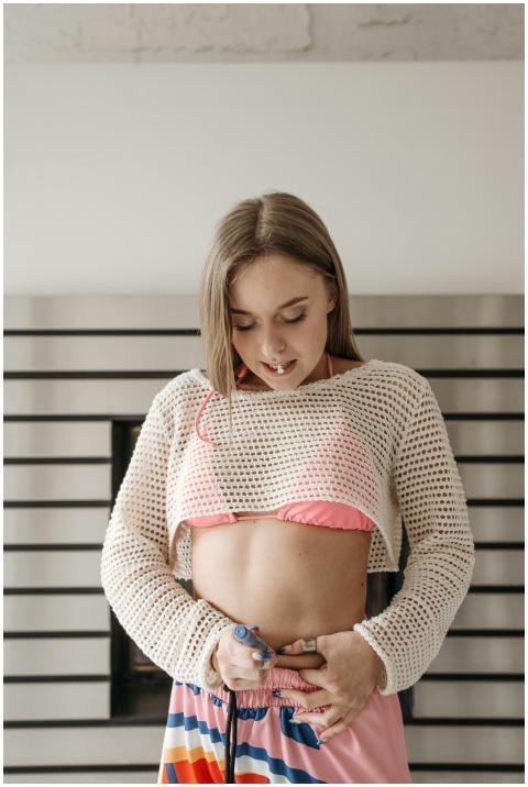 Young woman administering insulin injection, showc