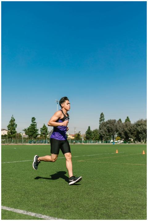 Young male athlete running on a sunny day in sport