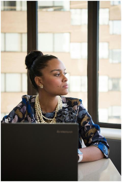 Businesswoman in stylish office attire working on