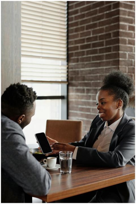 Two professionals discussing business over coffee